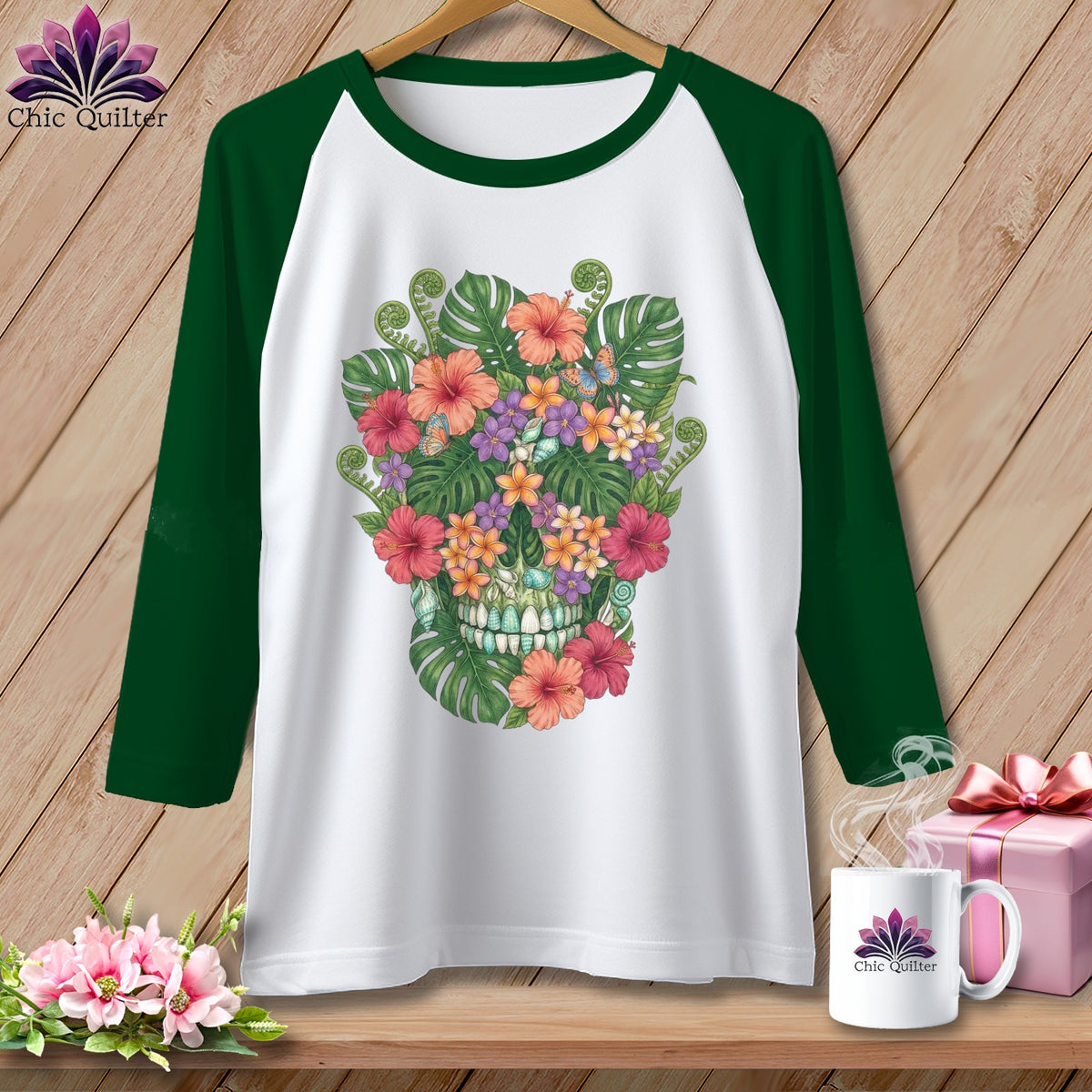 White baseball tee with a floral skull graphic and green sleeves.