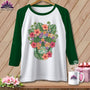 White baseball tee with a floral skull graphic and green sleeves.