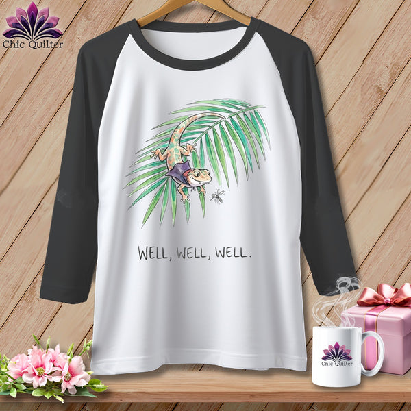 White baseball tee with a gecko on a leaf and the text "Well, Well, Well."