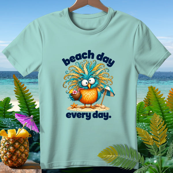 Light blue t-shirt with cartoon bird holding a coconut drink and umbrella, text "beach day every day."