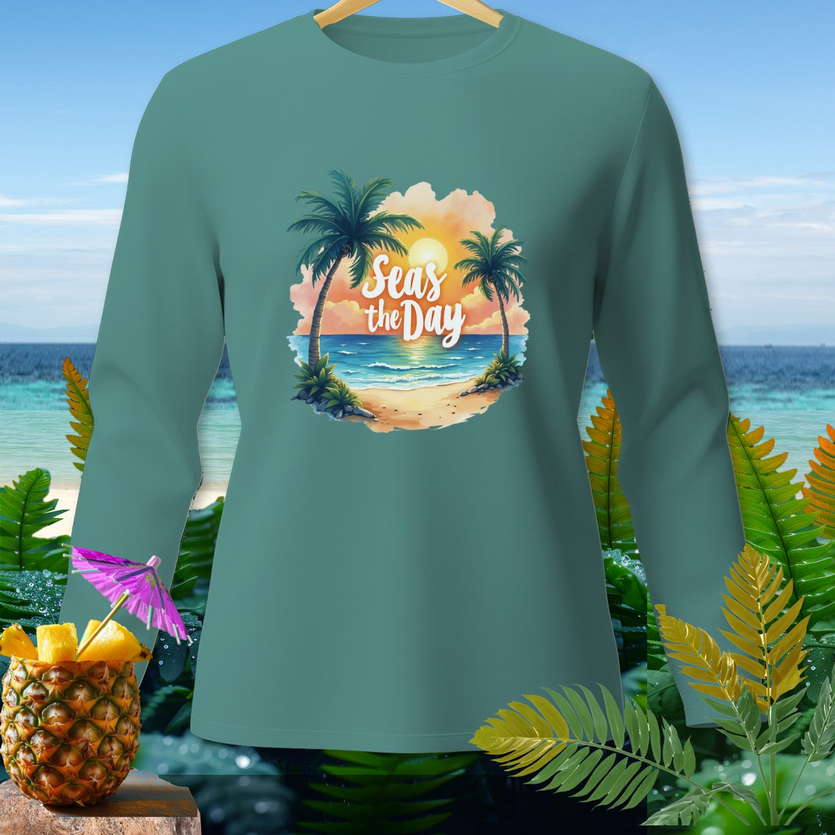 Teal long-sleeve shirt with "Seas the Day" tropical beach graphic.
