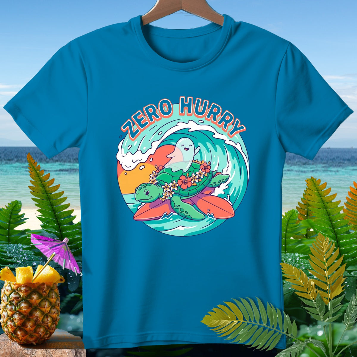 Blue t-shirt with a turtle and ghost surfing on a wave, text "Zero Hurry".