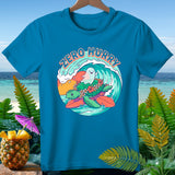 Blue t-shirt with a turtle and ghost surfing on a wave, text 