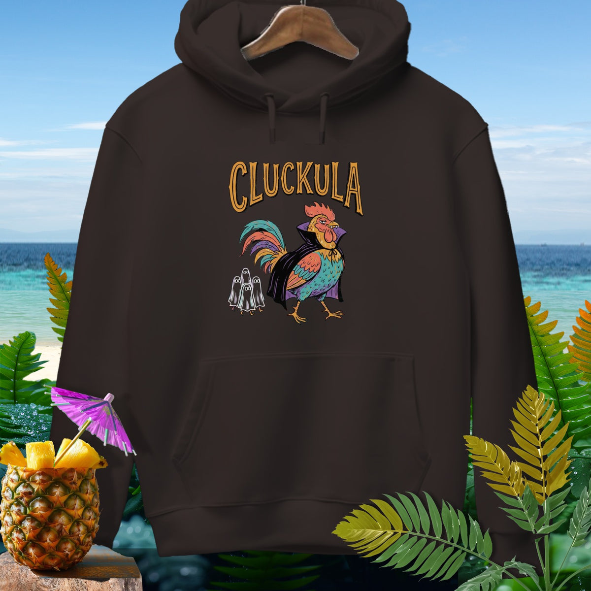 Dark brown hoodie with "CLUCKULA" text and a vampire rooster graphic.