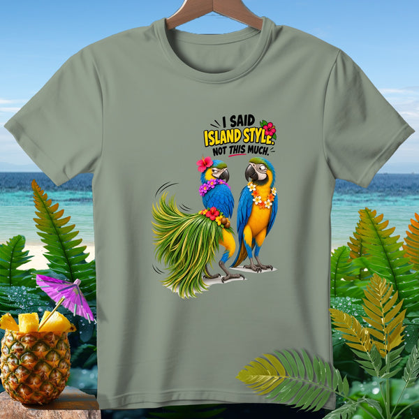 Two macaws wearing leis and flowers, with text "I SAID ISLAND STYLE. NOT THIS MUCH."