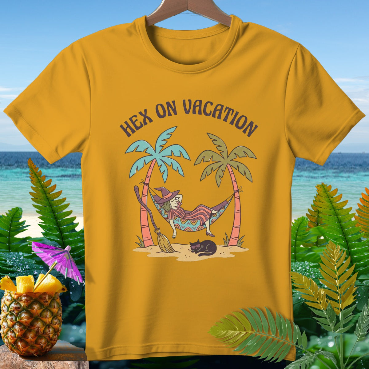 T-shirt with a witch relaxing in a hammock, text "Hex On Vacation".