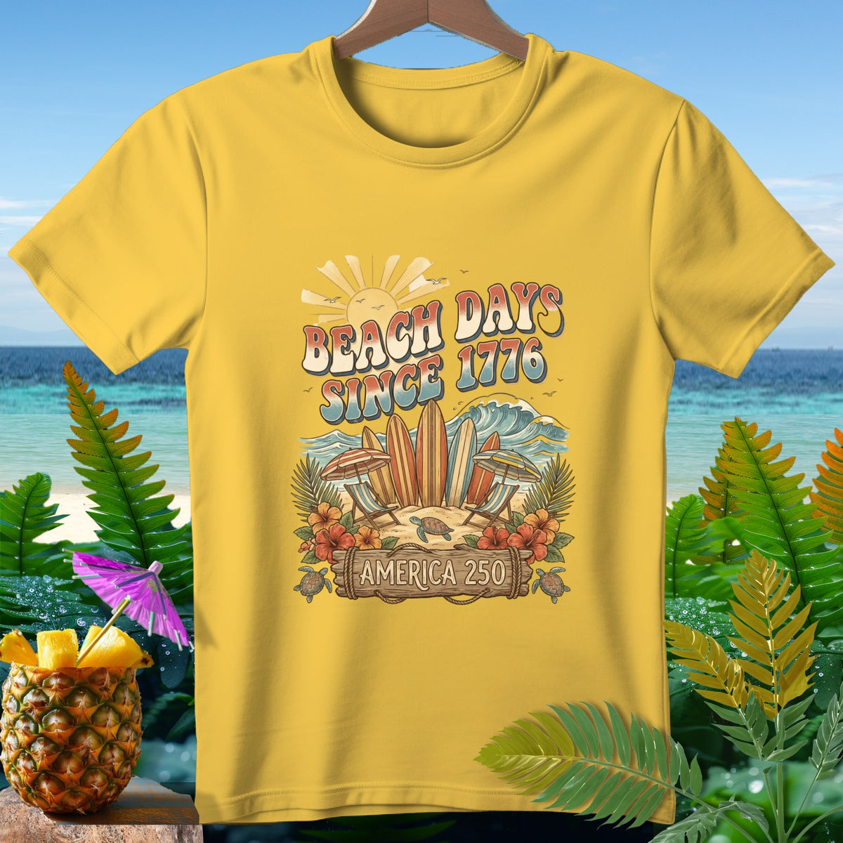 Yellow t-shirt with a retro graphic featuring surfboards, turtles, and the text "Beach Days Since 1776 America 250".