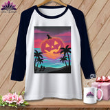 White and navy baseball tee with a Jack-o'-lantern on a beach at sunset.