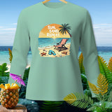 Mint green long sleeve shirt with beach graphic and text 