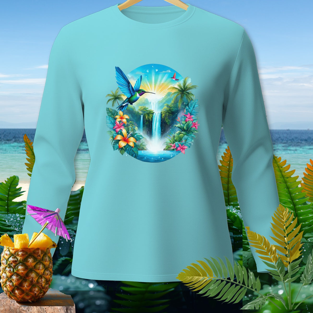 Light blue long-sleeve shirt with a tropical waterfall and hummingbird graphic.