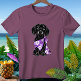 Black dachshund wearing a purple floral bandana on a maroon t-shirt.
