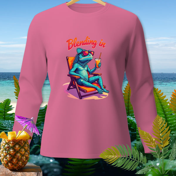 Pink long-sleeve shirt with a blue chameleon on a beach chair and text "Blending in."
