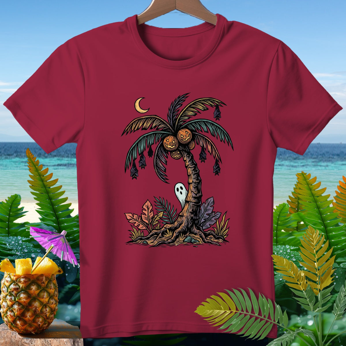 T-shirt with Halloween palm tree, pumpkins, bats, ghost, and crescent moon.