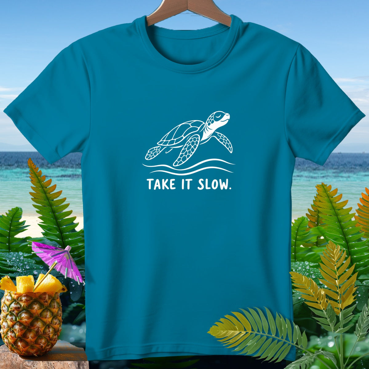 Teal t-shirt with a white sea turtle design and text "TAKE IT SLOW."
