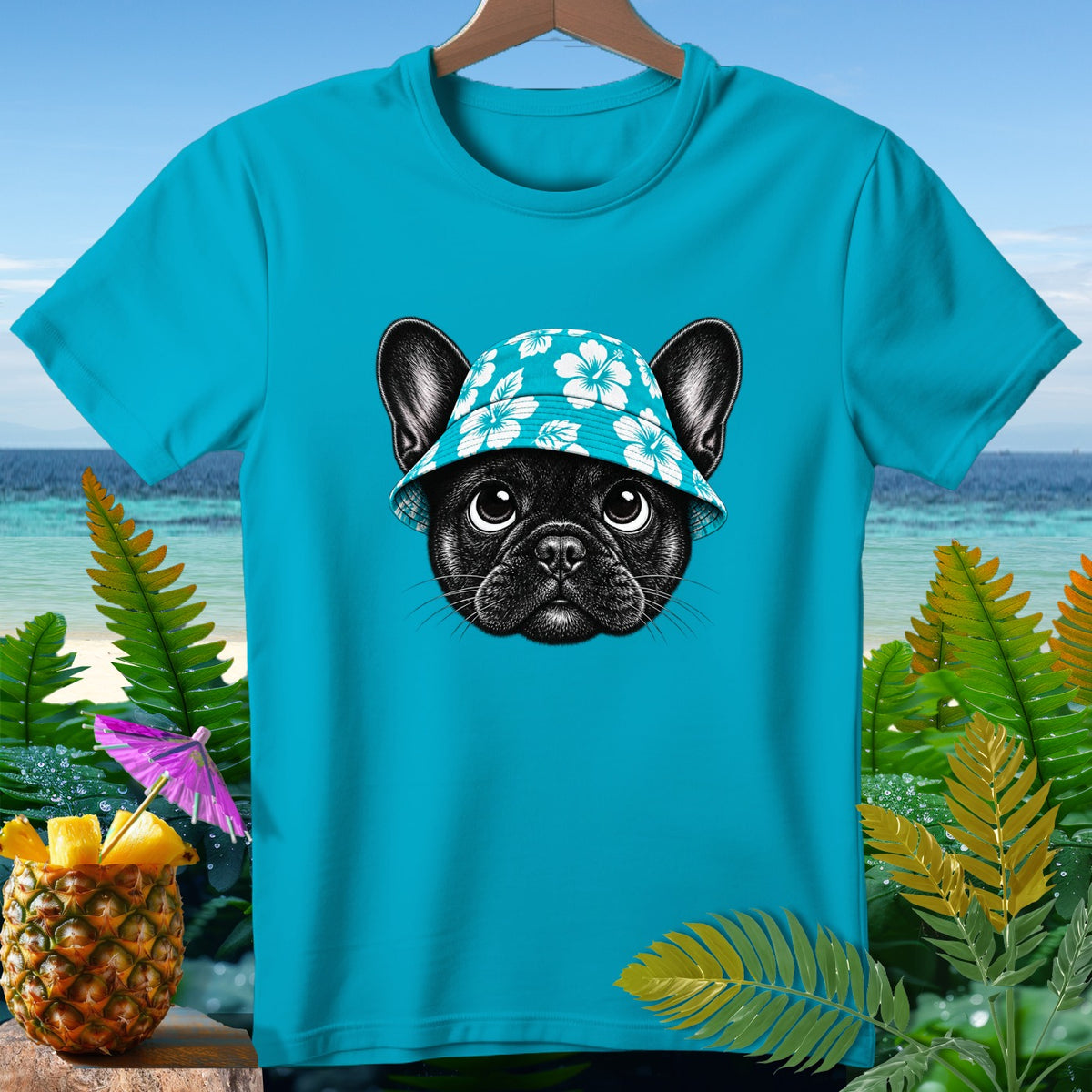 Turquoise t-shirt with black French bulldog wearing a floral hat and tropical background.