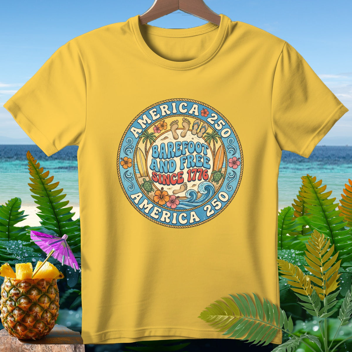 Yellow t-shirt with a circular graphic reading "AMERICA 250 BAREFOOT AND FREE SINCE 1776".