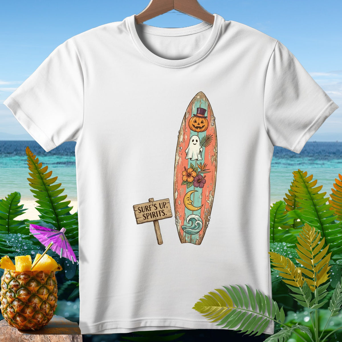White t-shirt featuring a surfboard with Halloween and beach motifs and a "Surf's Up, Spirits" sign.