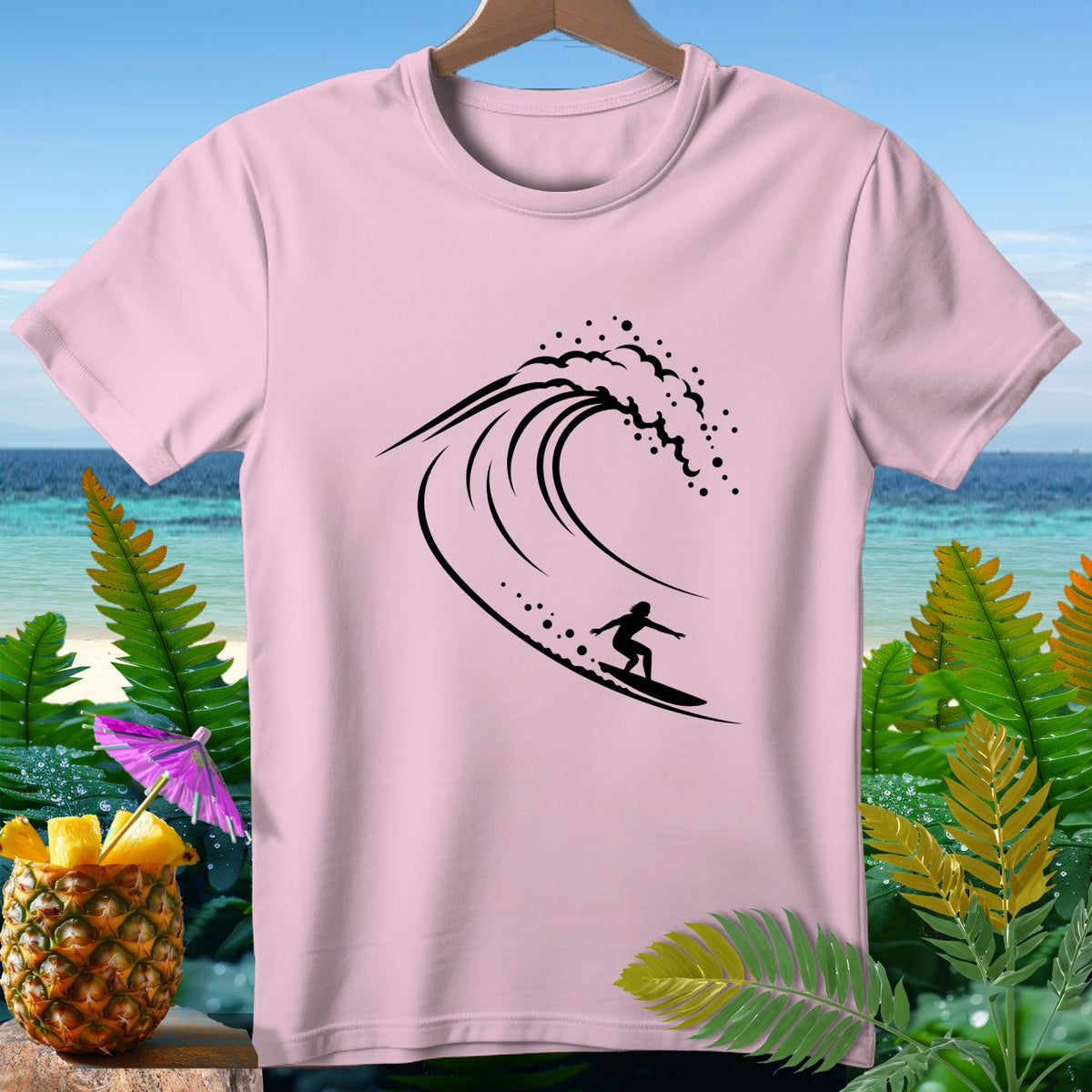 Pink t-shirt with black silhouette of a surfer riding a wave.