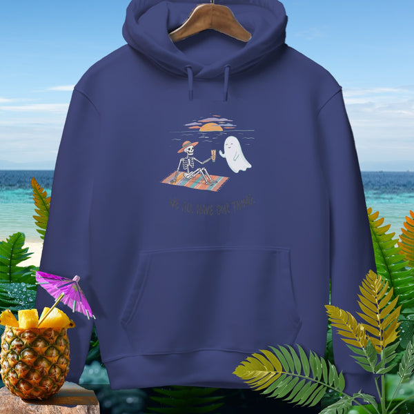 Skeleton and ghost enjoy drinks on beach blanket with text "We All Have Our Thngs."