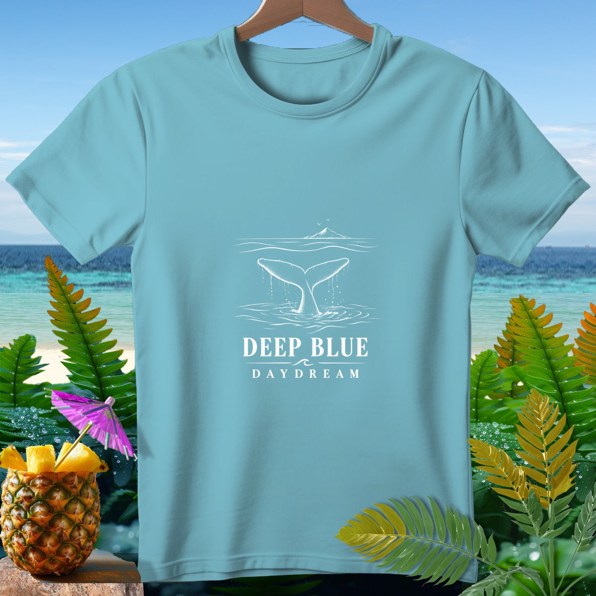 Light blue t-shirt with whale tail graphic and text "DEEP BLUE DAYDREAM".