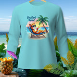 Light blue long sleeve shirt with cartoon fox on beach and text 