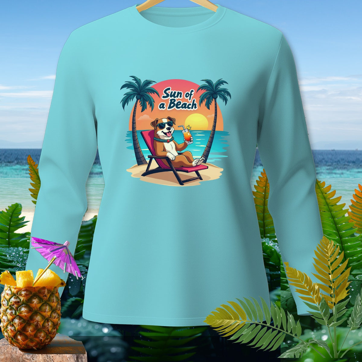 Light blue long-sleeve shirt with cartoon dog on beach chair, text "Sun of a Beach."