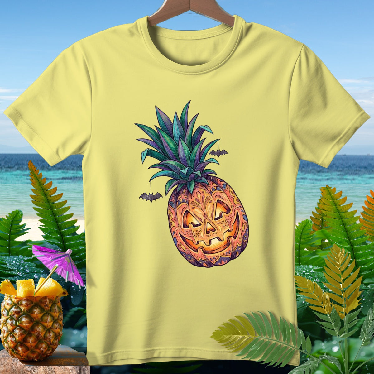 Yellow t-shirt with a pineapple carved like a jack-o'-lantern, with bats.
