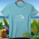 Light blue t-shirt with a wave and sun graphic and text 
