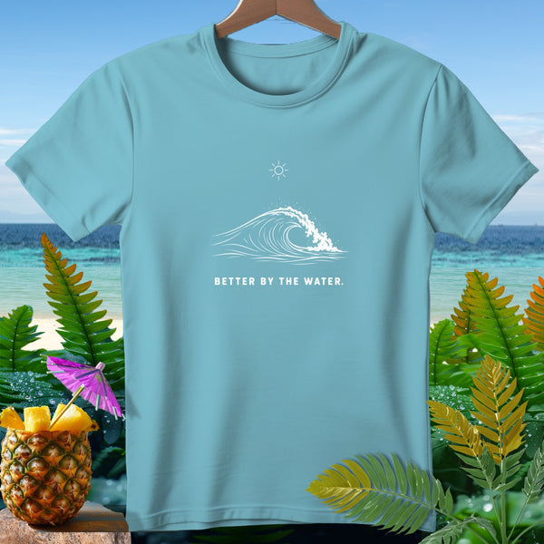 Light blue t-shirt with a wave and sun graphic and text "BETTER BY THE WATER."