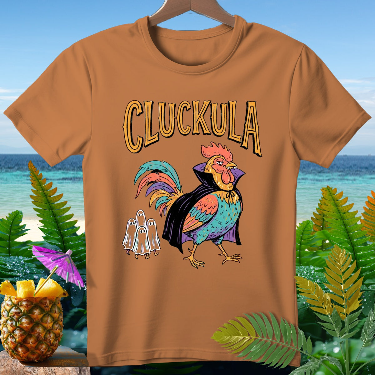 Orange t-shirt with "CLUCKULA" text and a rooster dressed as a vampire.