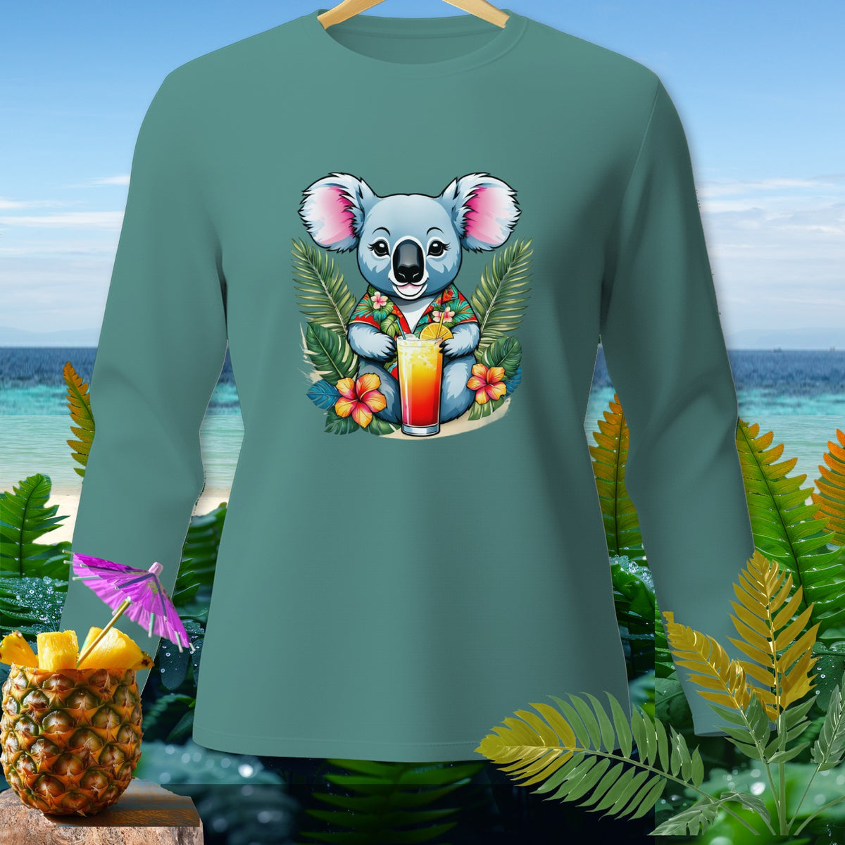 Teal long sleeve shirt with a cartoon koala holding a tropical drink and flowers.
