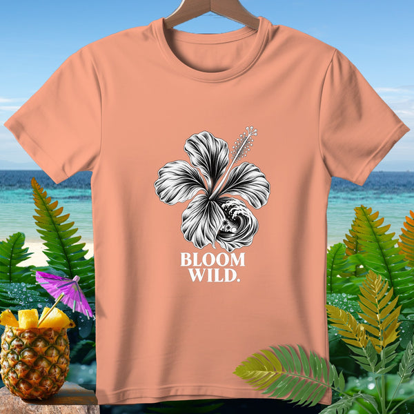 Peach t-shirt with black hibiscus graphic and "BLOOM WILD." text.