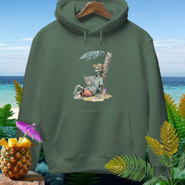 Skeleton reads "How to Relax" book under palm tree on beach with pineapple drink.