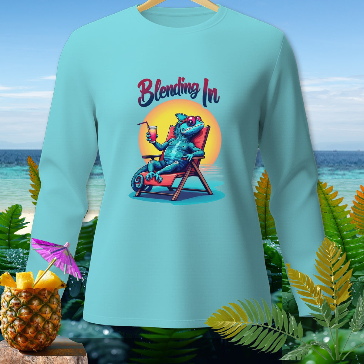 Light blue long-sleeve shirt with a blue chameleon on a beach chair and the text "Blending In".