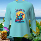 Light blue long-sleeve shirt with a blue chameleon on a beach chair and the text 