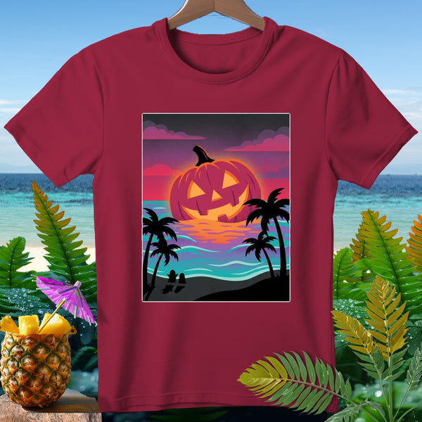 T-shirt with glowing Jack-o'-lantern, palm trees, beach, and ocean at sunset.