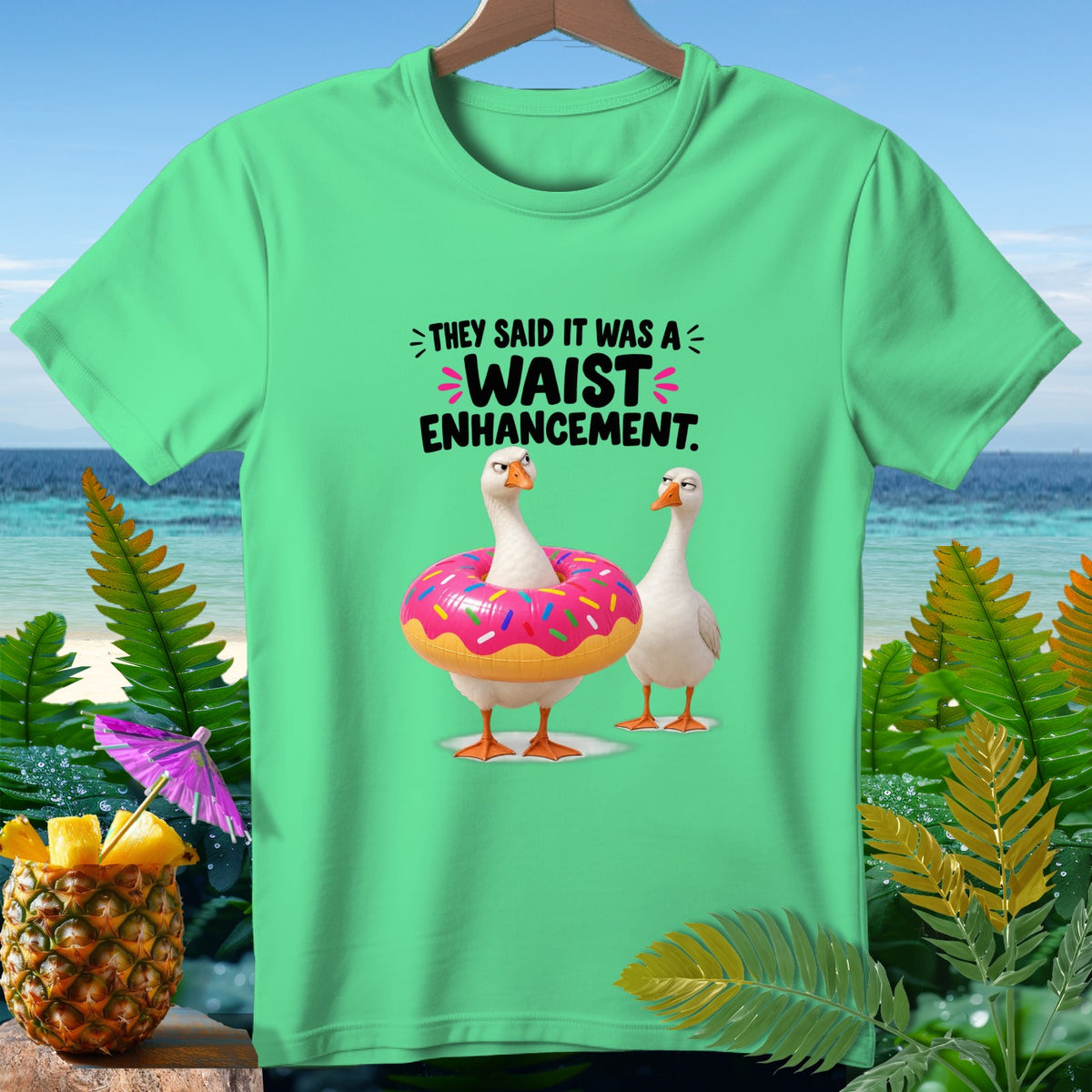 Green t-shirt with geese and text "They said it was a waist enhancement."