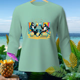 Light mint green long-sleeve shirt with graphic of two monkeys toasting drinks on beach chairs.