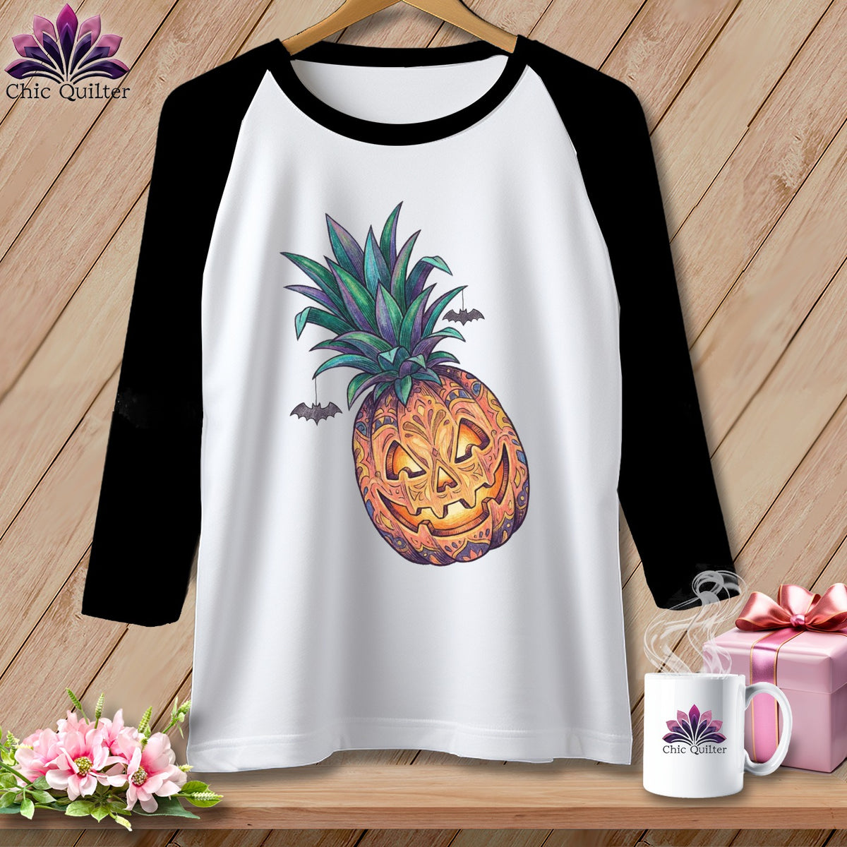 Raglan t-shirt with jack-o'-lantern pineapple graphic and small bats.