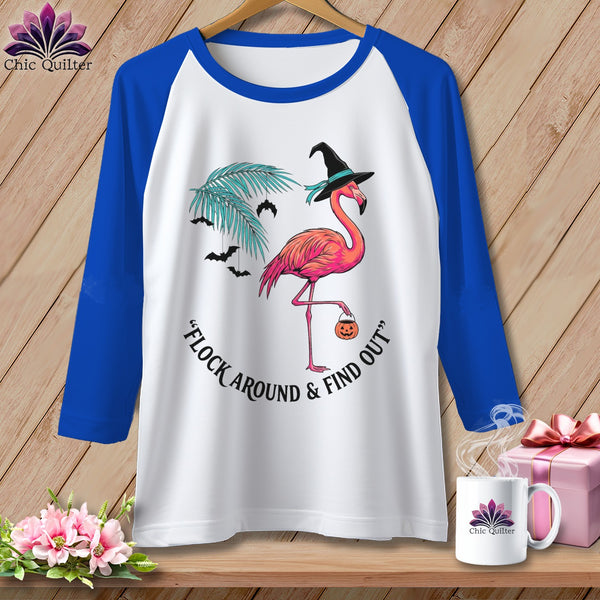 White t-shirt with blue sleeves featuring a flamingo in a witch hat with a pumpkin bag.