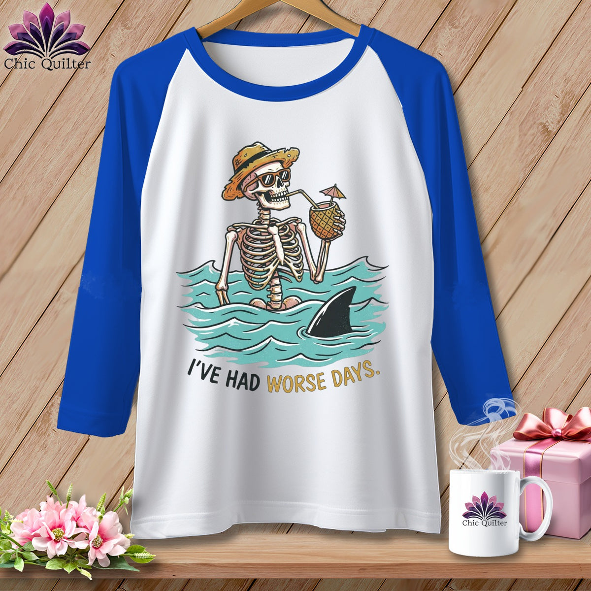Skeleton with hat and sunglasses drinks from pineapple, shark fin in water, text "I've Had Worse Days."