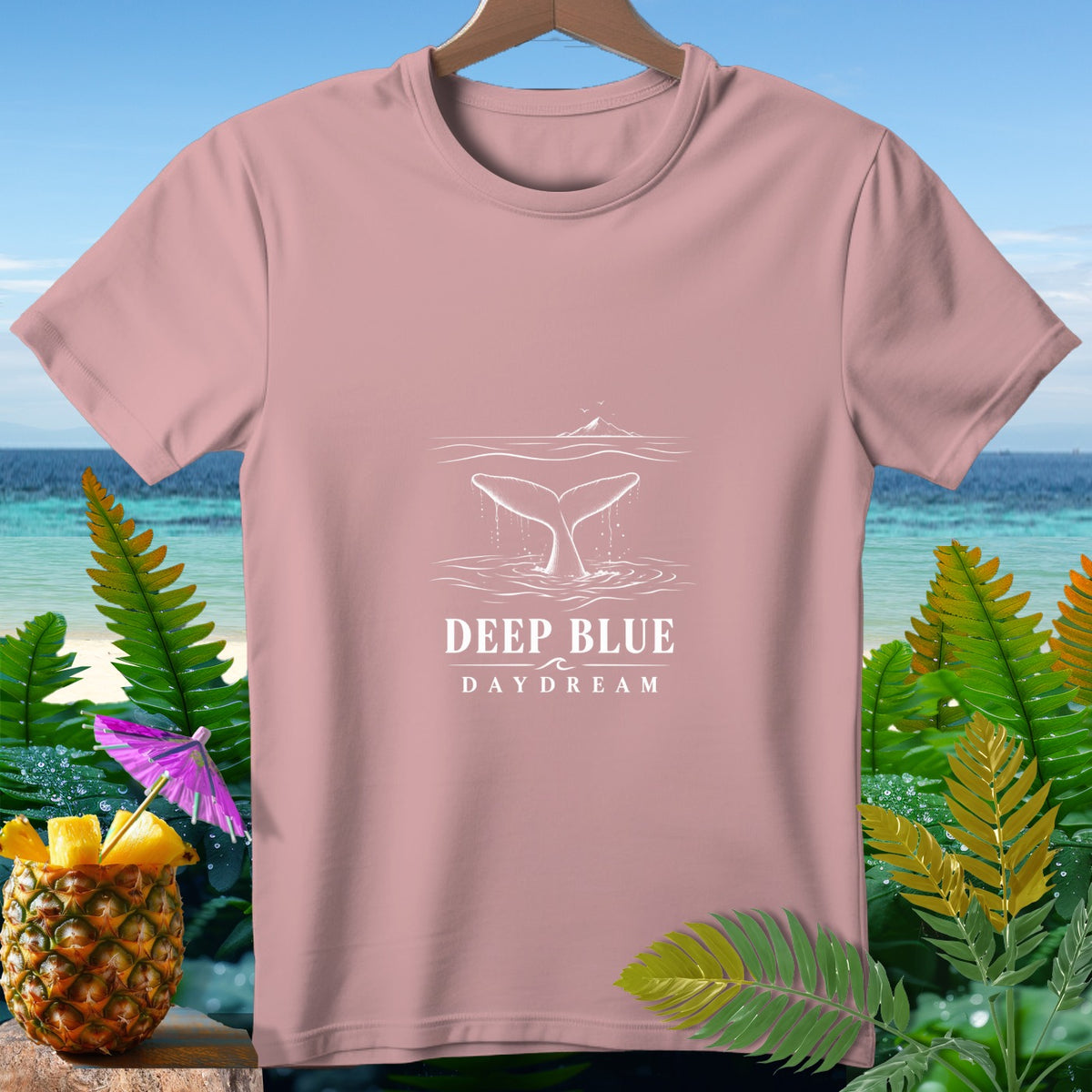 Pink t-shirt with white whale tail graphic and text "DEEP BLUE DAYDREAM".
