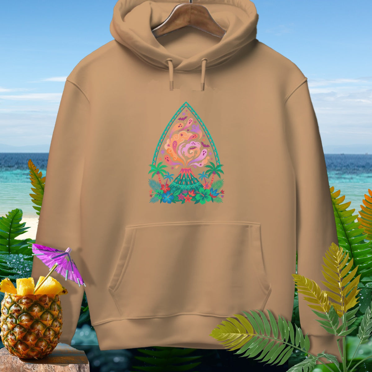 Tan hoodie with a tropical volcano graphic and a pineapple drink garnish.