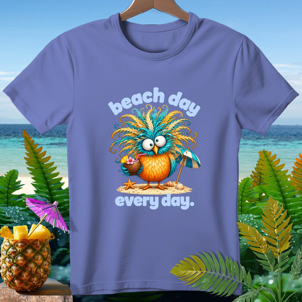 Purple t-shirt with cartoon bird holding coconut drink, text "beach day every day."