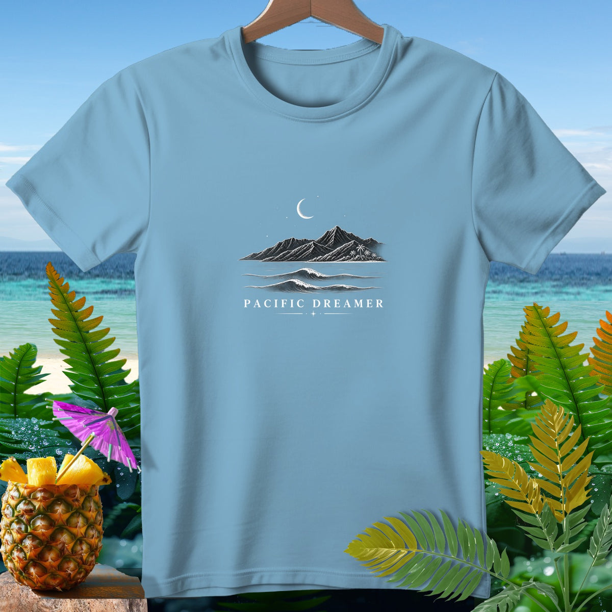 Light blue t-shirt with "Pacific Dreamer" text and mountain, wave, and moon graphic.