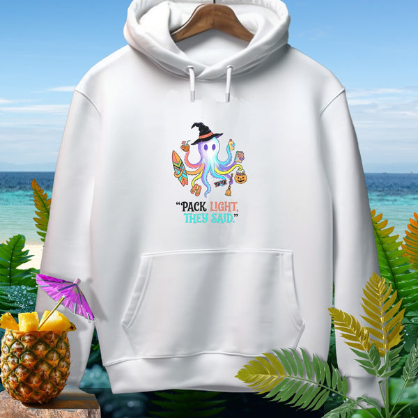 White hoodie with a colorful octopus wearing a witch hat and holding beach items. Text reads: "Pack Light, They Said."