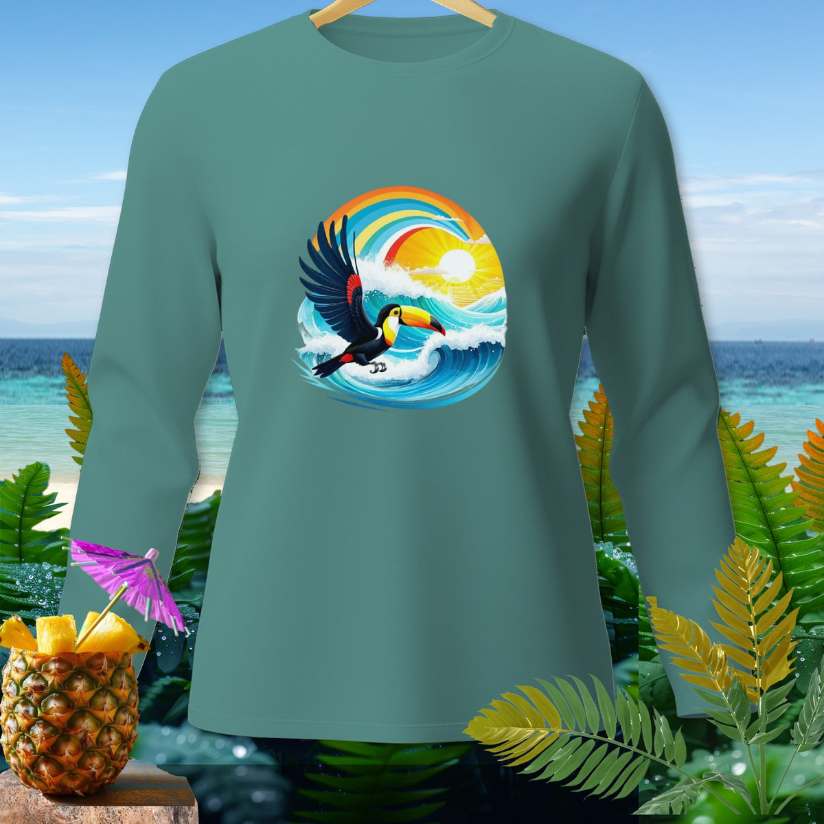 Teal long-sleeve shirt with toucan, waves, rainbow, and sun graphic.