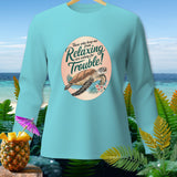 Light blue long sleeve shirt with a graphic of a turtle and text about relaxing trouble.