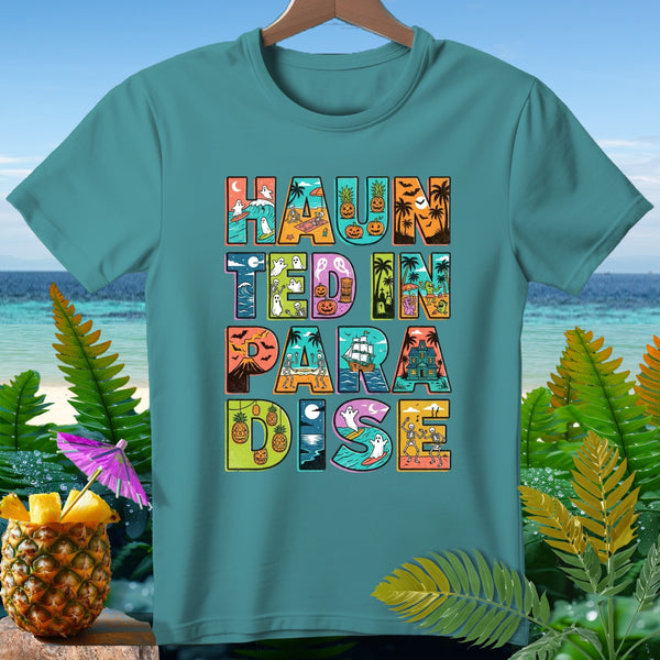 Teal t-shirt with "Haunted in Paradise" text featuring Halloween and beach-themed illustrations.