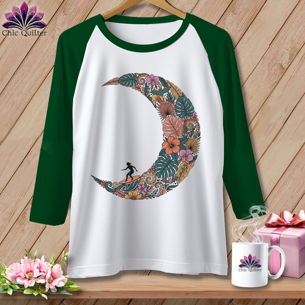 White baseball tee with a crescent moon floral design and surfer graphic.